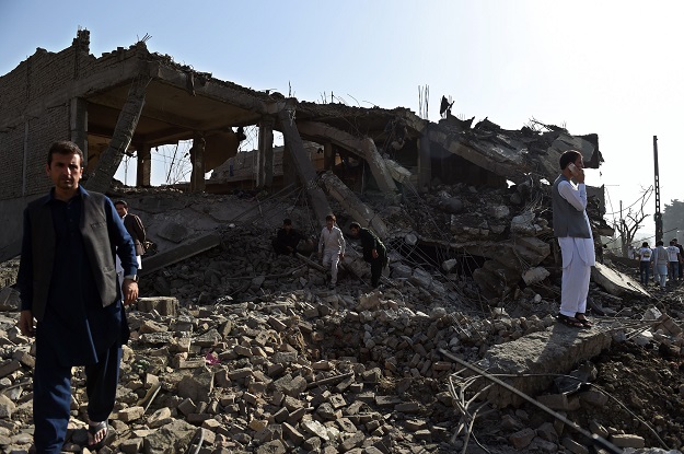 afghan residents inspect a damaged building following a powerful truck bomb explosion in kabul on august 7 2015 photo afp