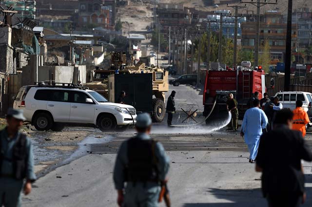 afghan firefighters hose down the street outside camp integrity a base housing us special forces that was attacked by militants in kabul on august 8 2015 photo afp