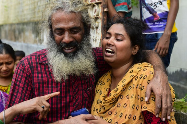 asha moni r the wife of murdered bangladeshi blogger niloy chakrabarti who used the pen name niloy neel weeps outside her home in dhaka on august 8 2015 photo afp asha moni r the wife of murdered bangladeshi blogger niloy chakrabarti who used the pen name niloy neel weeps outside her home in dhaka on august 8 2015 photo afp