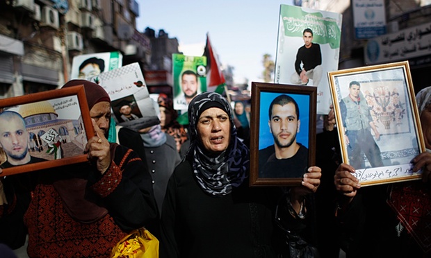 demonstrators hold pictures of prisoners during a demonstration in support of palestinin hunger strikers in israeli jails in the west bank city of ramallah photo reuters