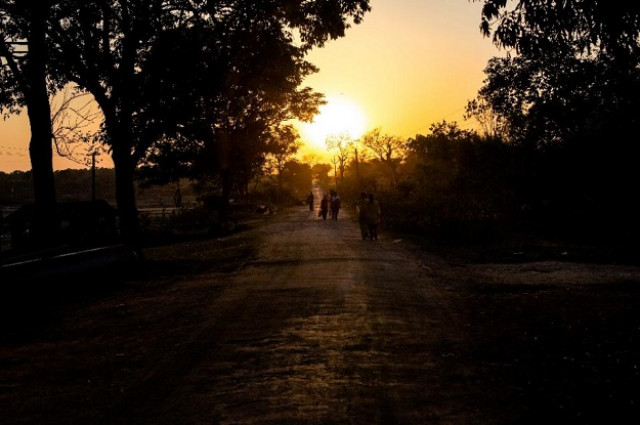 residents walk along a rural road in a village near ranchi on march 22 2015 photo afp residents walk along a rural road in a village near ranchi on march 22 2015 photo afp