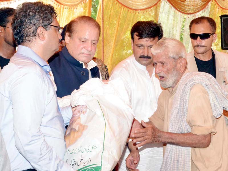 pm nawaz sharif distributes relief goods among flood affected people in isakhel mianwali on saturday photo ppi