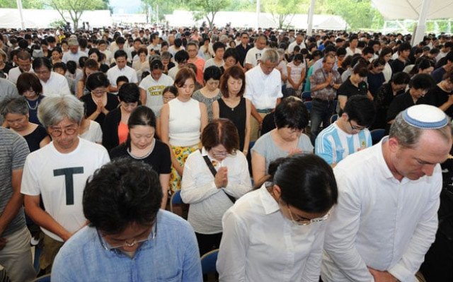 people offer silent prayers during the memorial ceremony to mark the 70th anniversary of the atomic bombing of nagasaki on august 9 2015 photo afp people offer silent prayers during the memorial ceremony to mark the 70th anniversary of the atomic bombing of nagasaki on august 9 2015 photo afp