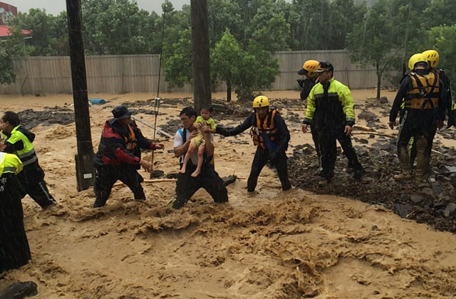 this handout picture taken on august 8 2015 and released on august 9 2015 by the new taipei city fire department shows rescue personnel moving an 8 year old girl to safety in wulai new taipei city as typhoon soudelor hit taiwan typhoon soudelor moved towards china august 9 weaker but still packing a punch after killing at least five people and leaving a trail of destruction in taiwan photo afp