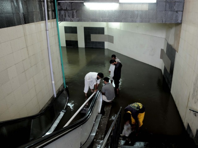 metro bus station drowned into rain water photo express