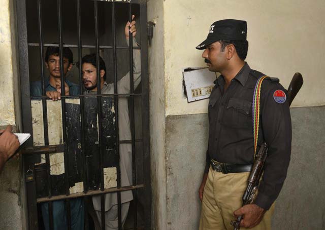 arrested gang members of a sexual abuse scandal stand in the police lockup as they speak to the media in hussain khanwala village on august 9 2015 photo afp