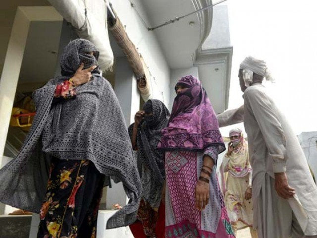 villagers gather at a house after the authorities announced a judicial inquiry into a massive child abuse scandal in hussain khanwala village some 55 kms southwest of lahore on august 9 2015 photo afp