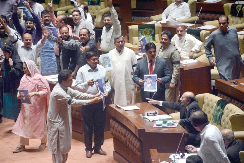 mqm lawmakers waved photos of their deceased worker during the sindh assembly session on monday they held the cm responsible for the murder photo rashid ajmeri express