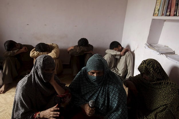 children whose families say have been abused hide their faces while their mothers are interviewed by a reuters correspondent in their village of husain khan wala photo reuters