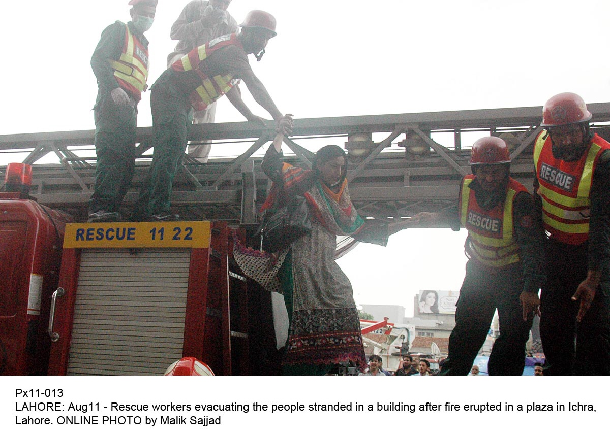 rescue workers evacuate stranded people from the building after fire erupted in lahore photo online