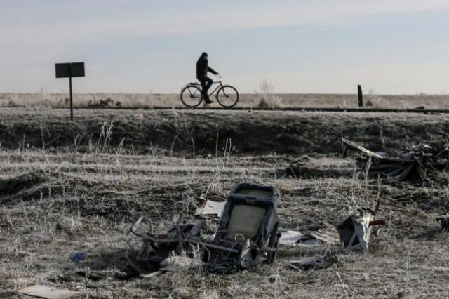 a man rides his bicycle past the wreckage of the malaysia airlines flight mh17 near the village of hrabove grabovo in donetsk region in this december 15 2014 photo reuters a man rides his bicycle past the wreckage of the malaysia airlines flight mh17 near the village of hrabove grabovo in donetsk region in this december 15 2014 photo reuters