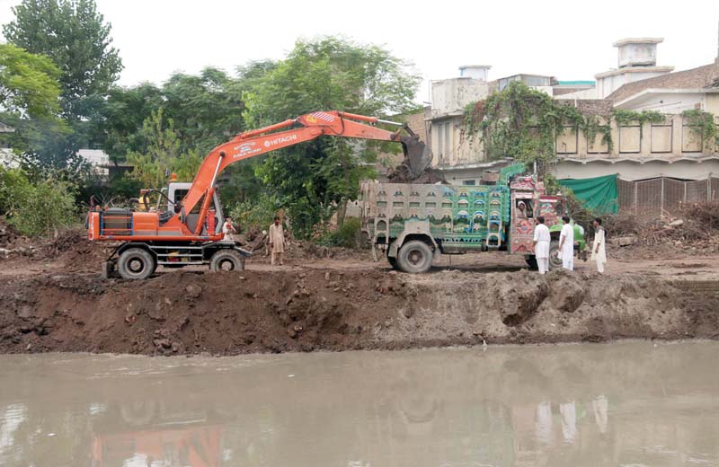 construction work under way along budhni nullah photo muhammad iqbal express