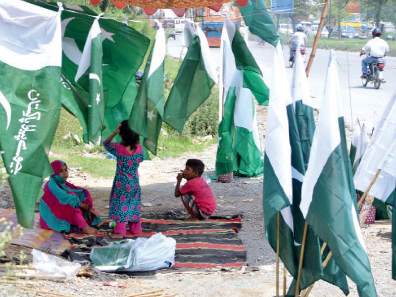 a family sells national flags which are in demand these days at their makeshift stall on ijp road photo mudassar raja express
