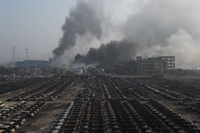 smoke billows behind rows of burnt out volkswagen cars at the site of a series of explosions in tianjin northern china on august 13 2015 photo afp smoke billows behind rows of burnt out volkswagen cars at the site of a series of explosions in tianjin northern china on august 13 2015 photo afp