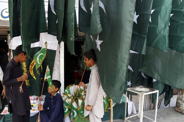 national flags buntings and souvenirs are being selling in connection of the pakistan 039 s sixty eight independence day celebration in peshawar photo ppi