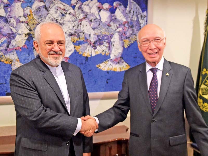 sartaj aziz shakes hands with javad zarif at the foreign ministry in islamabad photo afp