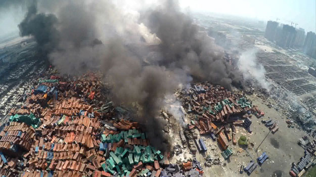 this screen grab taken from afptv shows an aerial image taken on august 13 2015 of smoke rising from debris the day after a series of explosions hit a chemical warehouse in the city of tianjin in northern china photo afp