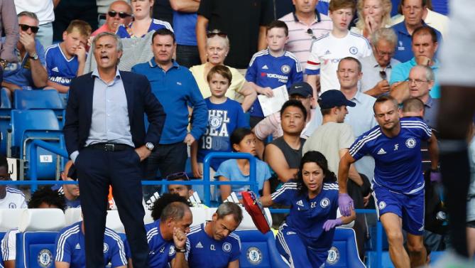 chelsea doctor 2r eva carneiro and head physio jon fearn r leave the bench to treat eden hazard as manager jose mourinho l gestures during the english premier league football match between chelsea and swansea city in london on august 8 2015 photo afp