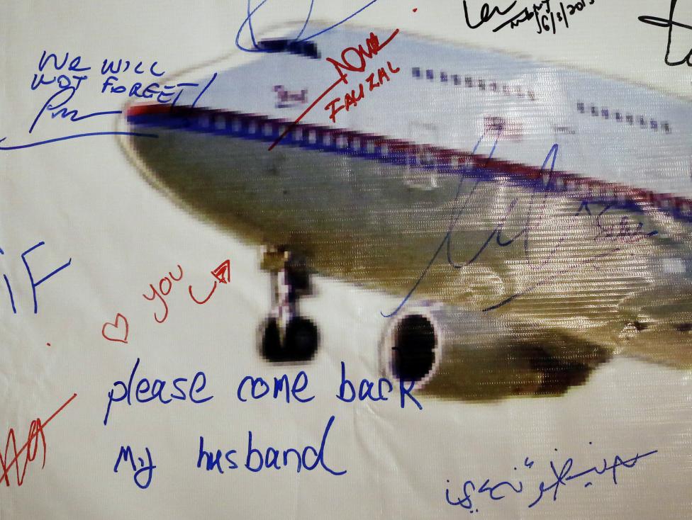 a message left on a board of remembrance by kelly last name not given 29 the wife of a passenger aboard missing malaysia airlines flight mh370 at a vigil ahead of the one year anniversary of its disappearance in kuala lumpur photo reuters