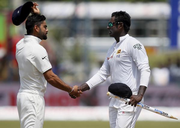 sri lanka 039 s captain mathews l shakes hands with india 039 s captain kohli r after sri lanka won their first test cricket match against india in galle phot reuters