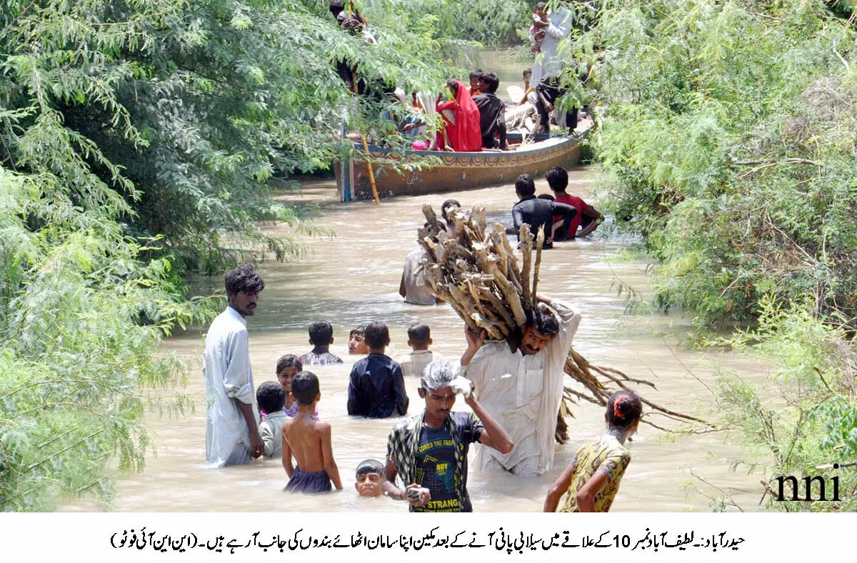 people going to safe areas with belongings after flood water inundated the latifabad area in hyderabad on august 15 photo nni people going to safe areas with belongings after flood water inundated the latifabad area in hyderabad on august 15 photo nni