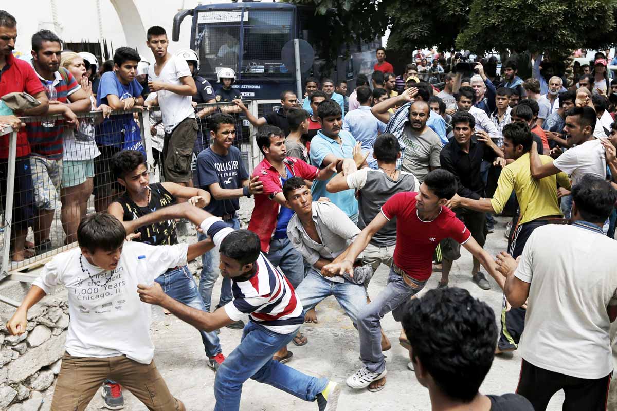 pakistani iranian and afghani migrants scuffle outside the police station of the city of kos over priority at a registration queue on the greek island of kos august 15 2015 photo reuters