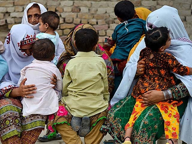 women hold their children as they gather at a house at wasayo village in rato dero in the district of larkana pakistan photo getty women hold their children as they gather at a house at wasayo village in rato dero in the district of larkana pakistan photo getty