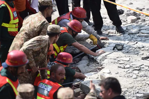 rescuers gather at the site of a blast at punjab home minister shuja khanzada 039 s political office in attock on august 16 2015 photo afp rescuers gather at the site of a blast at punjab home minister shuja khanzada 039 s political office in attock on august 16 2015 photo afp