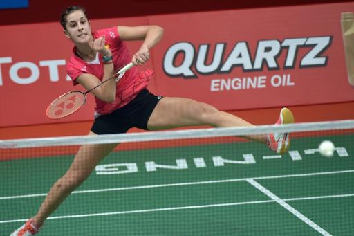 world number one carolina marin defended her women 039 s singles title on sunday with a two game victory over indian second seed saina nehwal photo afp