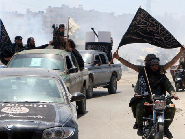 fighters from al qaeda 039 s syrian affiliate al nusra front drive in the syrian city of aleppo flying flags photo afp