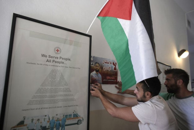 palestinians occupy the red cross headquarters in east jerusalem on august 16 2015 in solidarity with 31 year old mohammed allan portrait a palestinian held by israel without trial and who has reportedly slipped into a coma after a nearly two month hunger strike photo afp palestinians occupy the red cross headquarters in east jerusalem on august 16 2015 in solidarity with 31 year old mohammed allan portrait a palestinian held by israel without trial and who has reportedly slipped into a coma after a nearly two month hunger strike photo afp