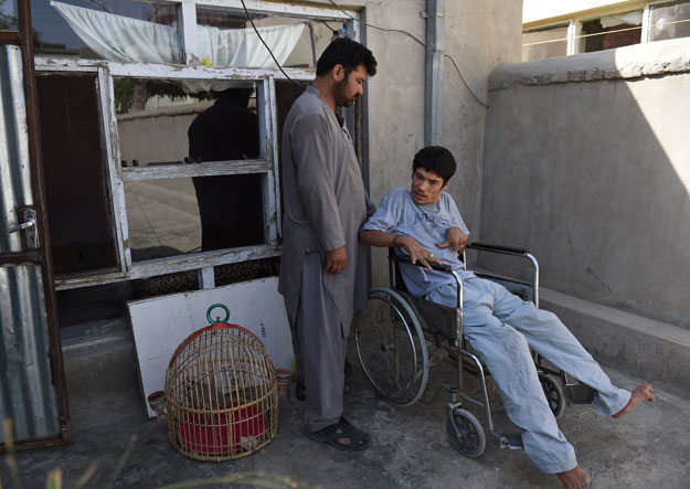 ashraf and his handicapped wheelchair bound brother are trying to seek asylum in another country photo afp