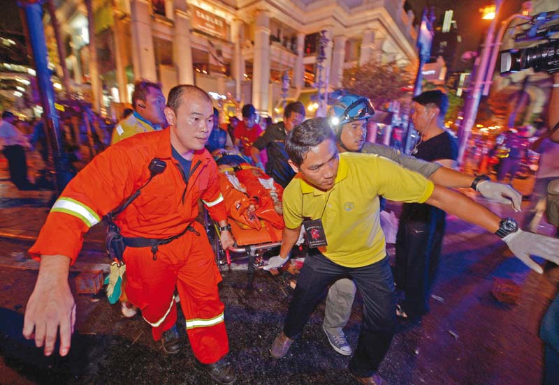 rescue workers carry an injured person following the explosion photo afp