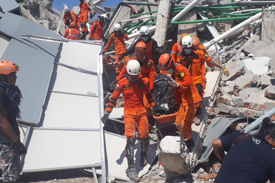 A body is recovered by Humas Basarnas in Palu, Indonesia. Reuters 