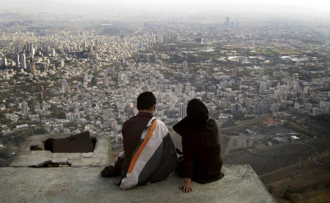 an iranian couple sit overlooking the city of tehran in this october 19 2006 file photo photo reuters