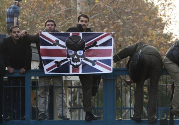 iranian protesters climb over the gate of the british embassy in tehran november 29 2011 photo reuters