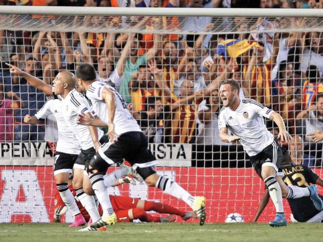 valencia s sofiane feghouli scored the third goal four minutes from time to put his side in a strong position for the return leg against monaco next week photo afp valencia s sofiane feghouli scored the third goal four minutes from time to put his side in a strong position for the return leg against monaco next week photo afp