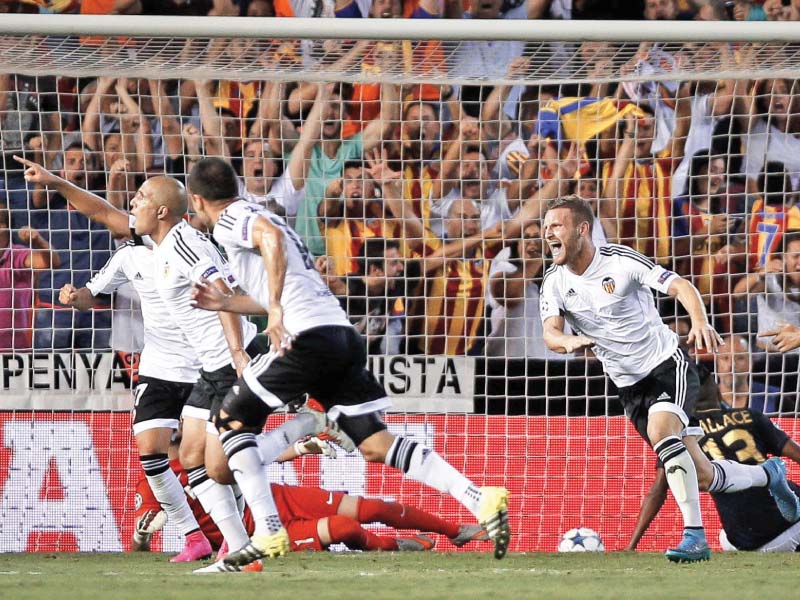 valencia s sofiane feghouli scored the third goal four minutes from time to put his side in a strong position for the return leg against monaco next week photo afp