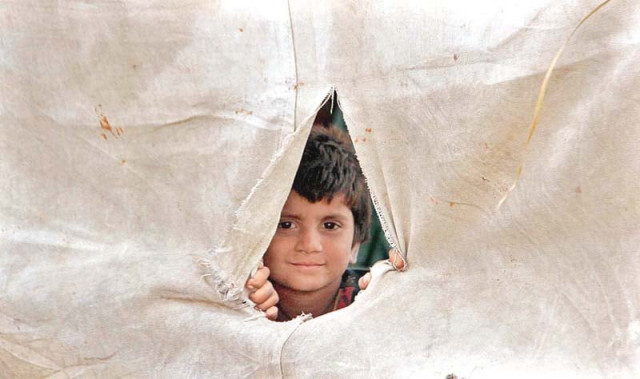 a girl peeps out of the tent at a flood relief camp in sujawal as the floodwaters passed areas in upper sindh their relief camps have stopped receiving rations while the ones in lower sindh are still working actively photo app a girl peeps out of the tent at a flood relief camp in sujawal as the floodwaters passed areas in upper sindh their relief camps have stopped receiving rations while the ones in lower sindh are still working actively photo app