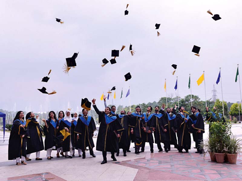 students celebrate at their graduation ceremony at the ist photo express