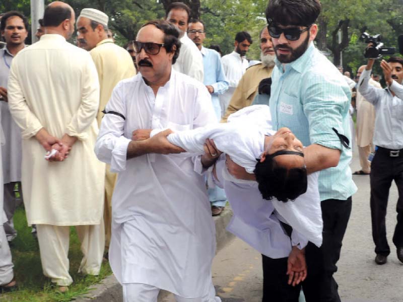 a nurse is being taken to a hospital after she fainted due to dehydration caused by sweltering heat left doctors and paramedical staffers of different hospitals stage protest on a main road in islamabad on thursday photos waseem nazir express inp