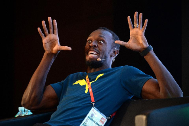 usain bolt reacts as he answers a question at a press conference ahead of the athletics world championships in beijing on august 20 2015 photo afp