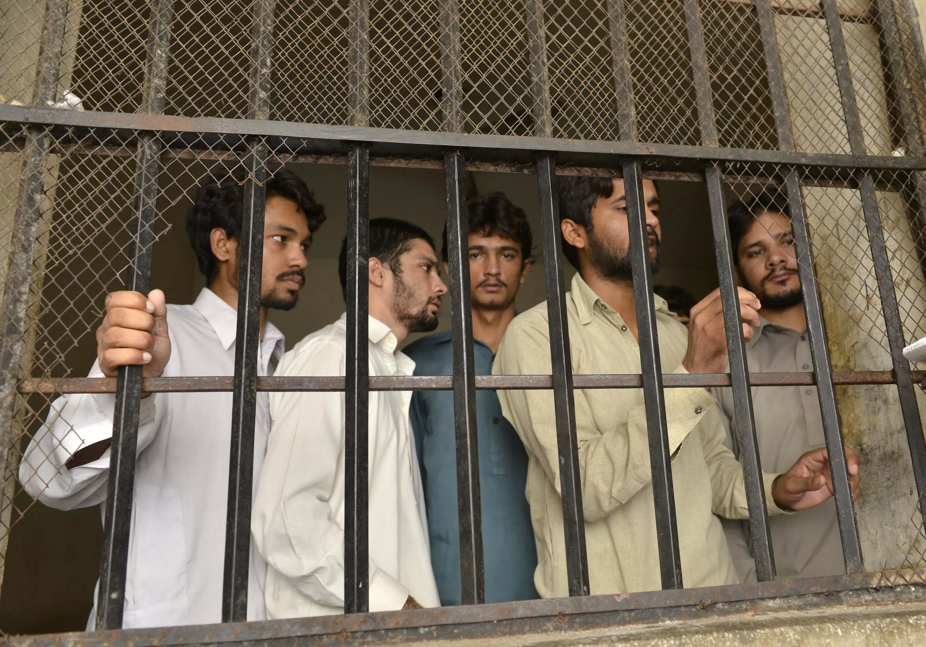 arrested gang members of a sexual abuse scandal stand in the police lockup in hussain khanwala village some 55 kms southwest of lahore on august 9 2015 photo afp arrested gang members of a sexual abuse scandal stand in the police lockup in hussain khanwala village some 55 kms southwest of lahore on august 9 2015 photo afp