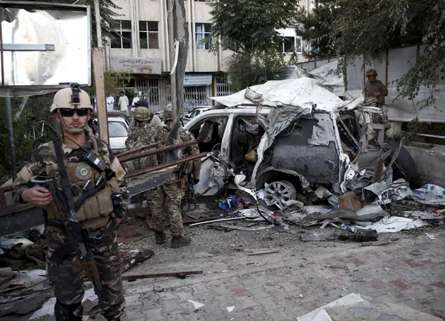 afghan security personnel l keeps watch next to a damaged car belonging to foreigners after a bomb blast in kabul afghanistan august 22 2015 photo reuters afghan security personnel l keeps watch next to a damaged car belonging to foreigners after a bomb blast in kabul afghanistan august 22 2015 photo reuters