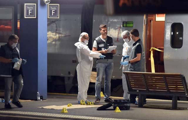 crime and forensic investigators stand on a platform next to a thalys train of french national railway operator sncf at the main train station in arras northern france on august 21 2015 photo afp