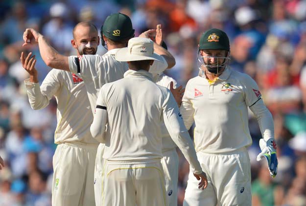 australia 039 s nathan lyon l celebrates with teammates after taking the wicket of england 039 s jonny bairstow as australia enforce a follow on on the third day of the fifth ashes cricket test match between england and australia at the oval in london on august 22 2015 photo afp