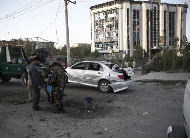 a damaged car is moved away from a crater caused by a car bomb blast in kabul afghanistan august 22 2015 photo reuters a damaged car is moved away from a crater caused by a car bomb blast in kabul afghanistan august 22 2015 photo reuters