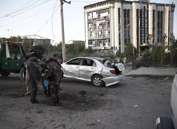a damaged car is moved away from a crater caused by a car bomb blast in kabul afghanistan august 22 2015 photo reuters a damaged car is moved away from a crater caused by a car bomb blast in kabul afghanistan august 22 2015 photo reuters