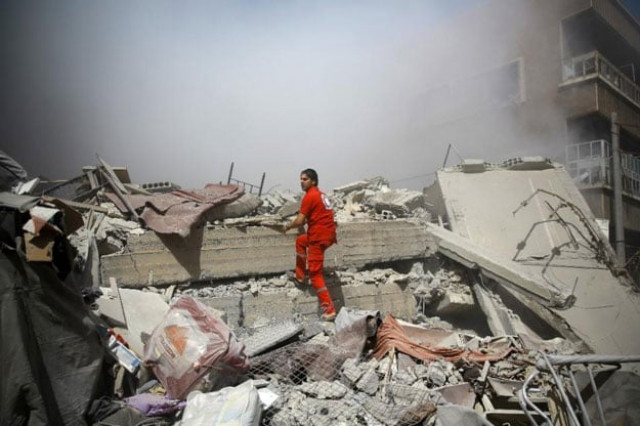 a member of the syrian red crescent inspects rubble searching for victims in the rebel held area of douma following shelling and air raids by syrian government forces on august 22 2015 photo afp a member of the syrian red crescent inspects rubble searching for victims in the rebel held area of douma following shelling and air raids by syrian government forces on august 22 2015 photo afp