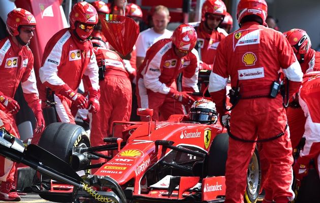 mechanics work on the car of ferrari 039 s german driver sebastian vettel in the pits at the spa francorchamps circuit in spa on august 23 2015 during the belgian formula one grand prix photo afp